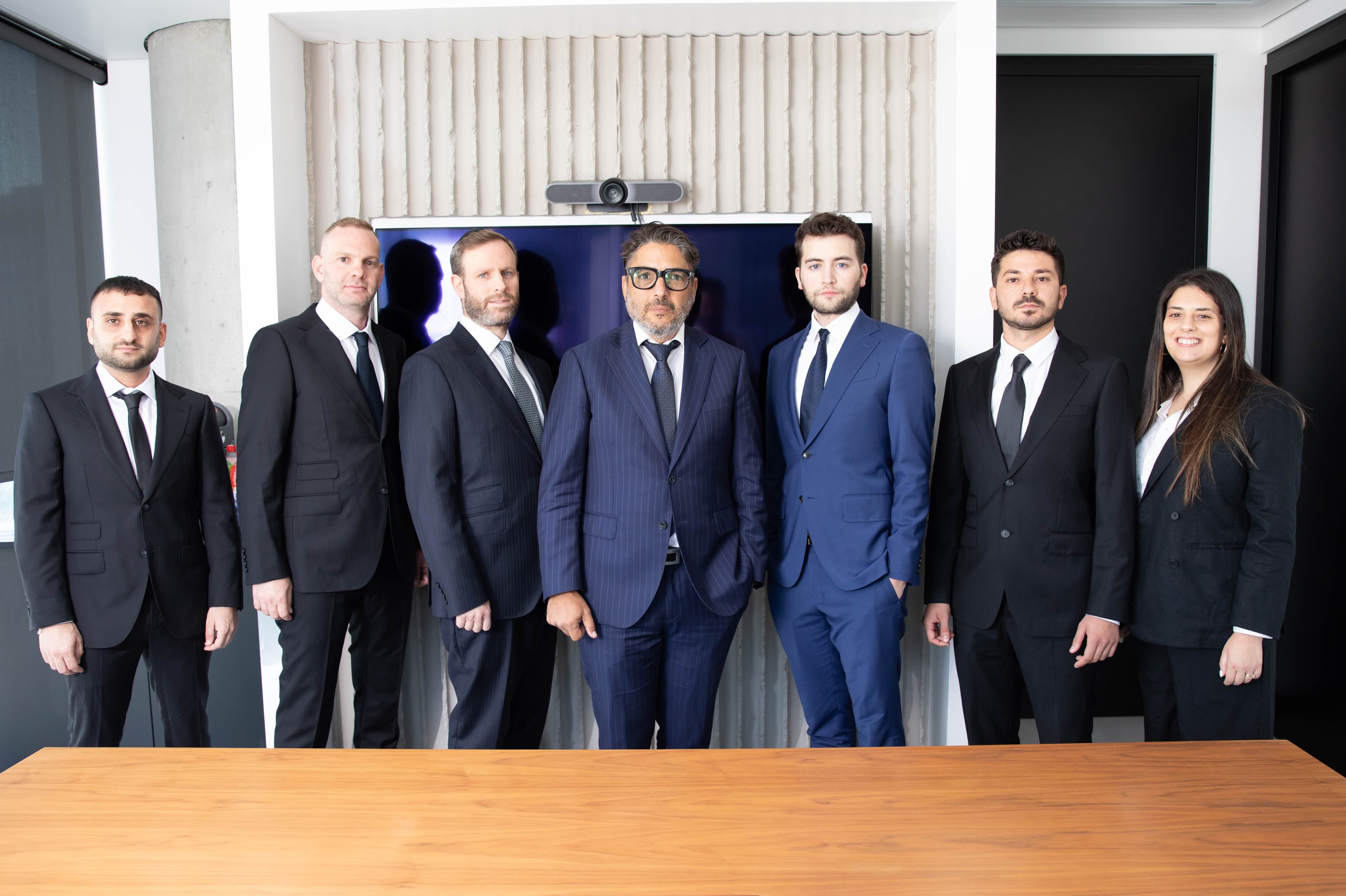 The Shlomi Vaknin & Co. team standing in the office conference room
